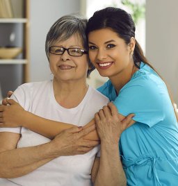 caretaker hugs elder lady